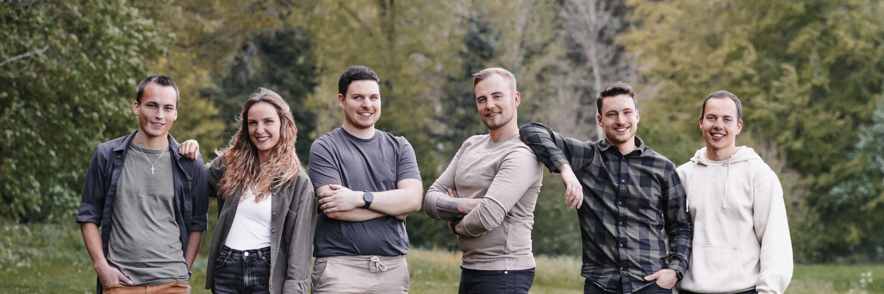 The band posing in a field
