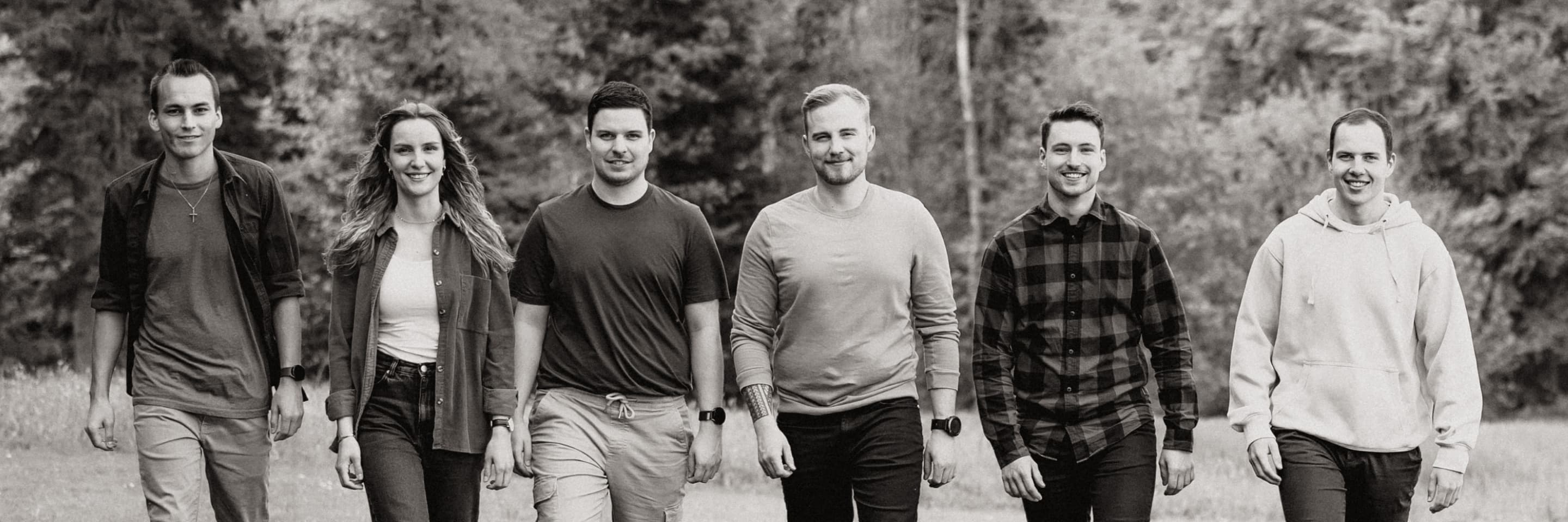 The band walking through a field, black and white